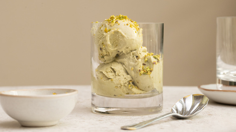 Scoops of pistachio ice cream in glass