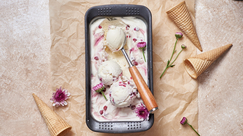 Pomegranate ice cream in loaf pan with pink edible flowers