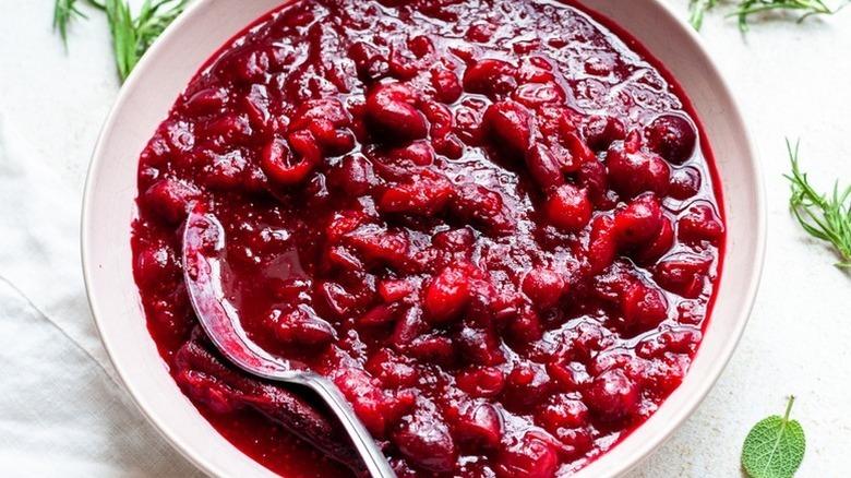 Cranberry sauce in bowl with spoon