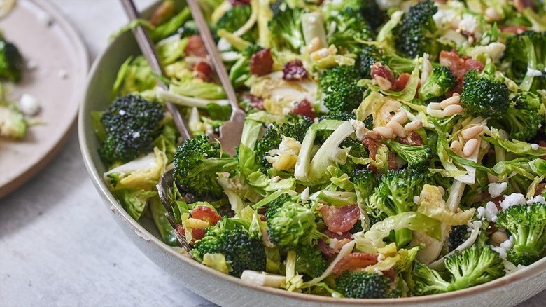 Bowl of broccoli, bacon, and shaved Brussels sprouts salad
