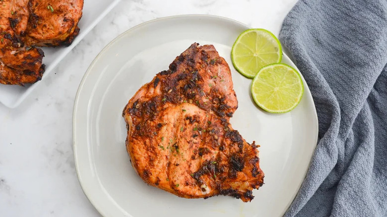 chipotle pork chop with lime on plate