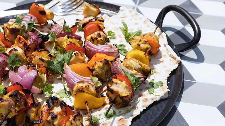 grilled chicken and vegetable kebabs on plate