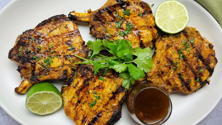 grilled tandoori pork chops on plate with lime