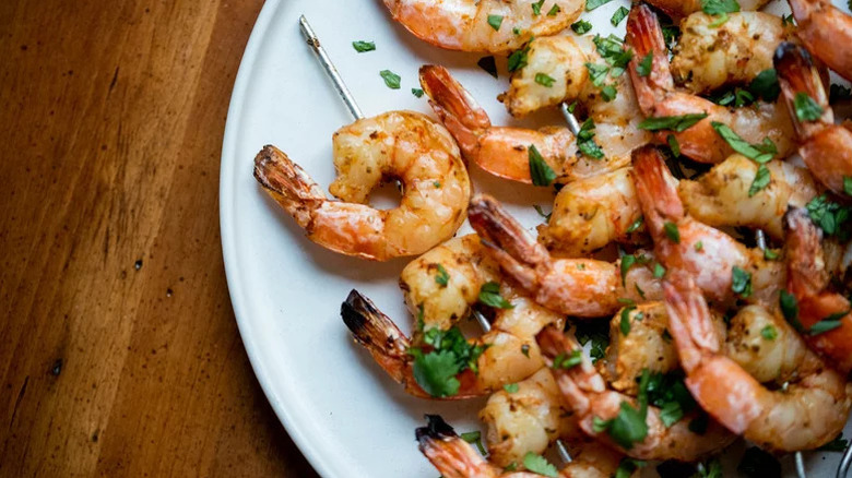 closeup of souvlaki-style grilled shrimp on plate