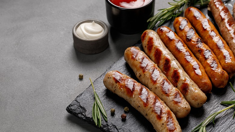 Grilled sausages on slate