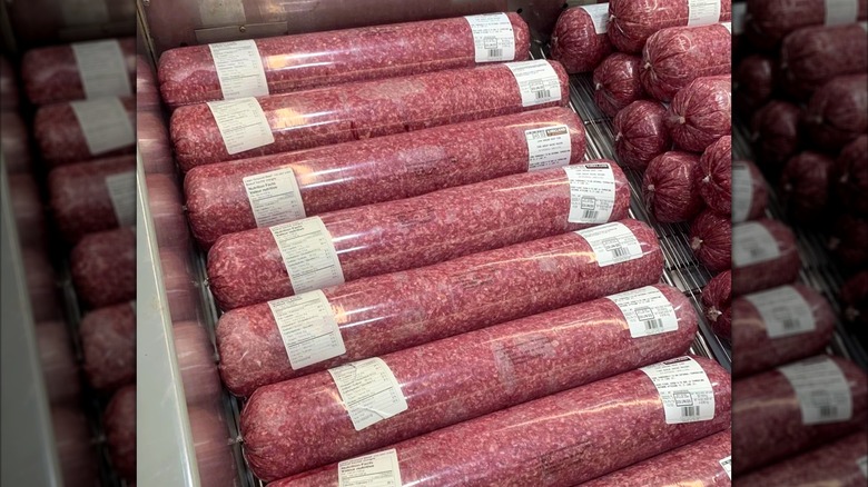 10-pound tubes of Kirkland Signature Ground Beef on display in cold case at Costco store