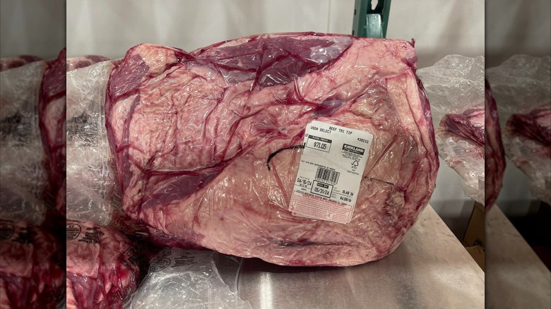 Kirkland Signature Whole Beef Tri Tip from Costco wrapped in plastic with white price tag sticker