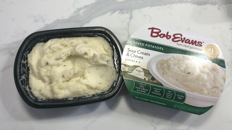 Bob Evans sour cream and chives mashed potatoes in a tub.