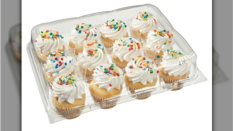 Cupcakes in a plastic container on white background