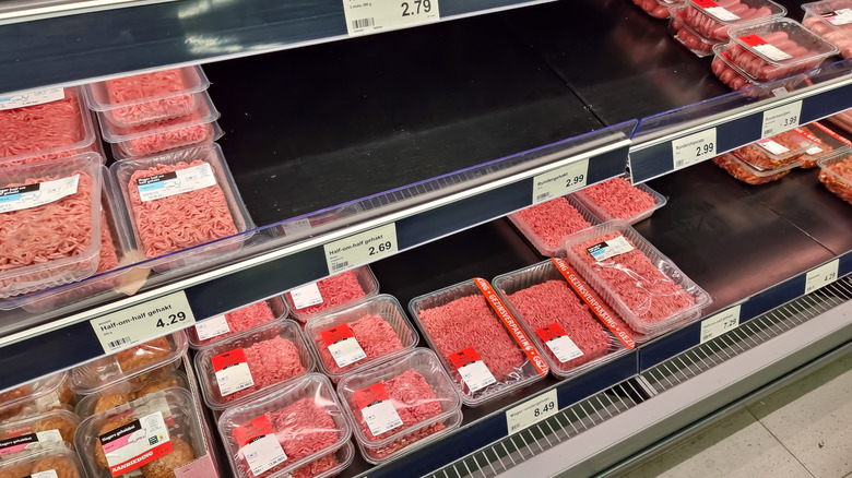 Shelves of meat products at Aldi with a big empty space