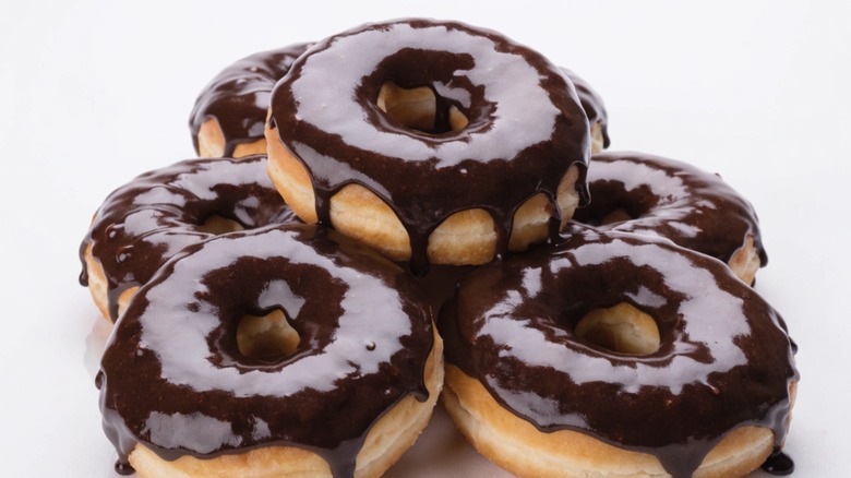 Chocolate glazed donuts against white background