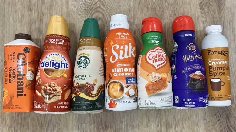 7 fall coffee creamer bottles lined up.