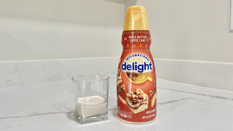International Delight Apple Butter Coffee Cake coffee creamer poured into a cup.