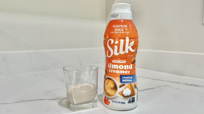 Silk Pumpkin Spice Almond Creamer poured into a cup.