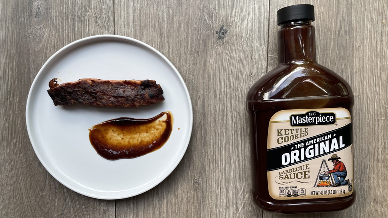 KC Masterpiece barbecue sauce with rib on a plate