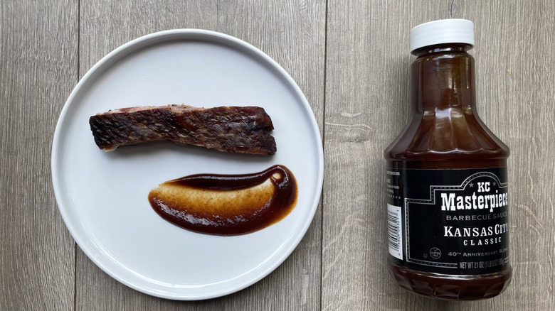 KC Masterpiece barbecue sauce with rib on a plate