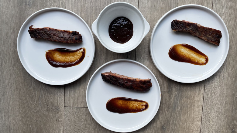 Assorted ribs and sauces on with plates and bowls