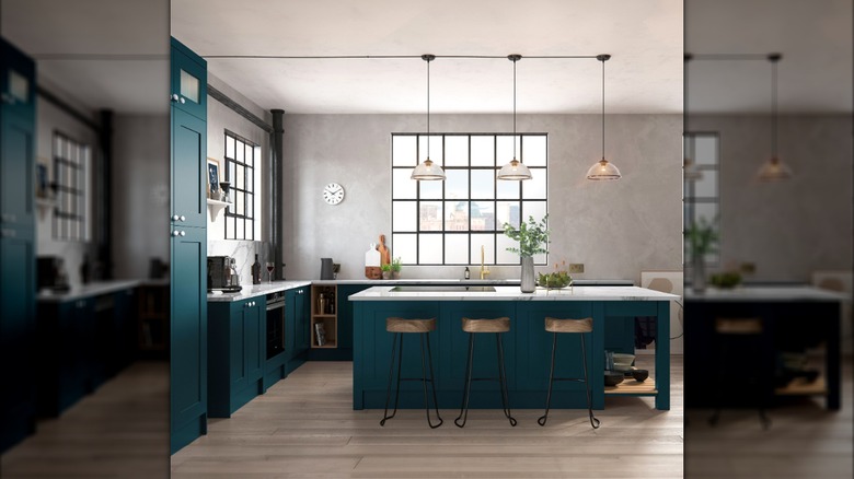 An airy kitchen with teal cabinets
