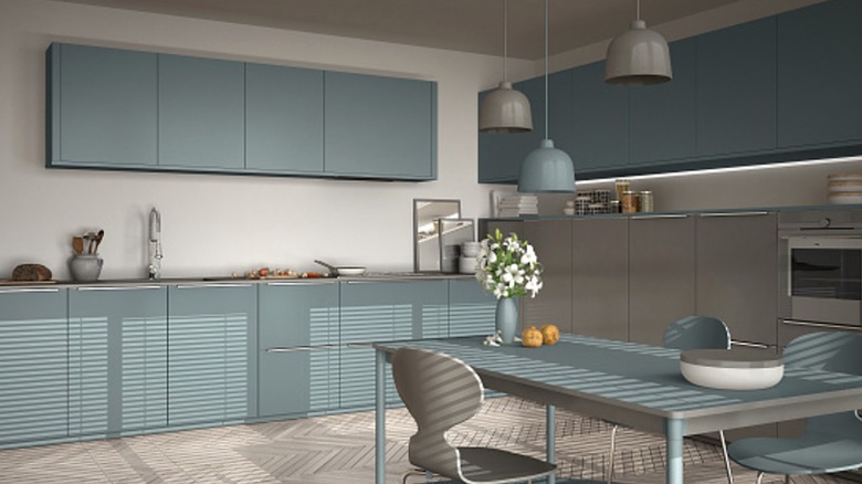 A kitchen with blue-gray cabinets