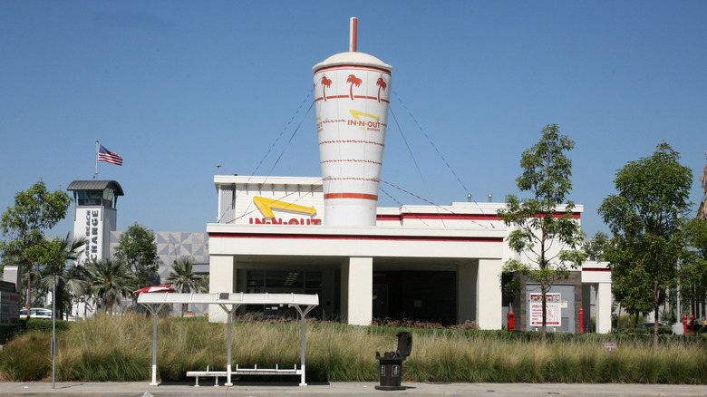 an In-N-Out restaurant with a giant inflatable milkshake on the roof