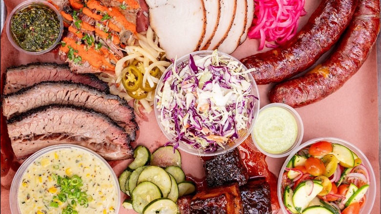 a tray of barbecue meats and sides