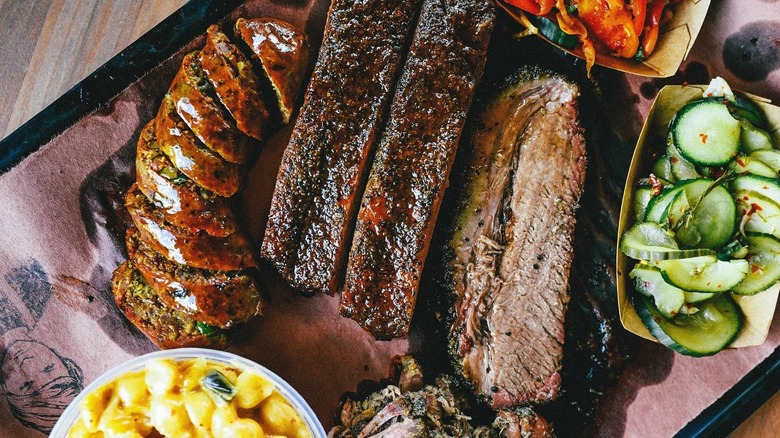 a tray of barbecue meats and sides