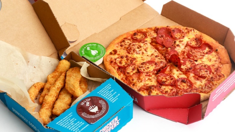 A small Domino's pizza with a side of chicken strips