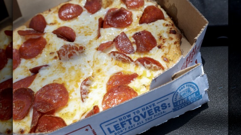 A very cheesy pepperoni pizza from Domino's in its box