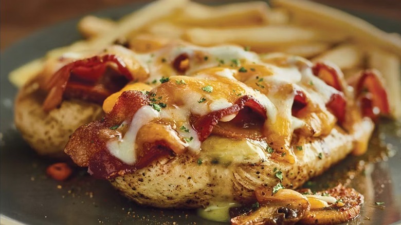 A beauty shot for the Outback menu of the Alice Springs Chicken with a side of fries