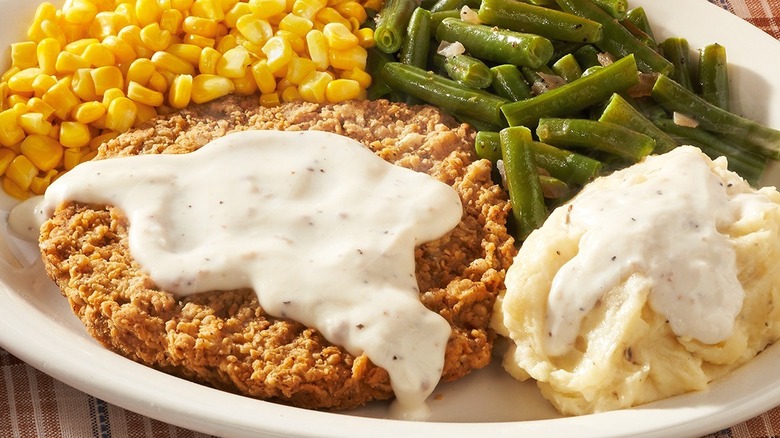 Country fried steak with gravy, corn, green beans, and mashed potatoes from Cracker Barrel