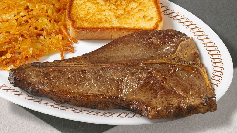 Waffle House T-bone steak with a slice of toast and hash browns on white plate
