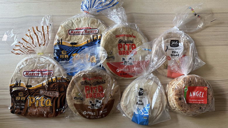 Packages of pita bread from various brands on wooden table