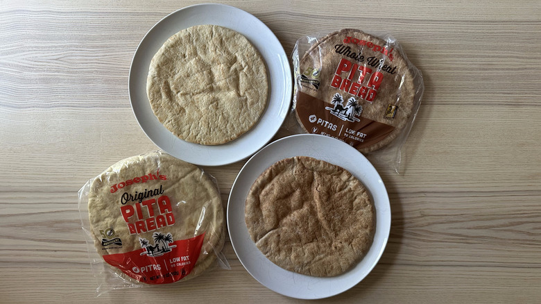 Joseph's Pita Bread packs on wooden table with two pitas on plates