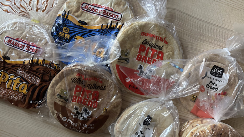 Packages of pita bread brands on wooden table