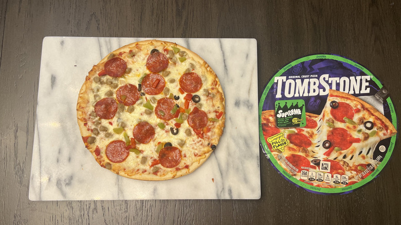 Tombstone Supreme Original Thin Crust Pizza on serving board.
