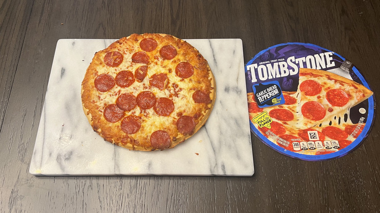 Tombstone Garlic Bread Crust Pepperoni Pizza on serving board.