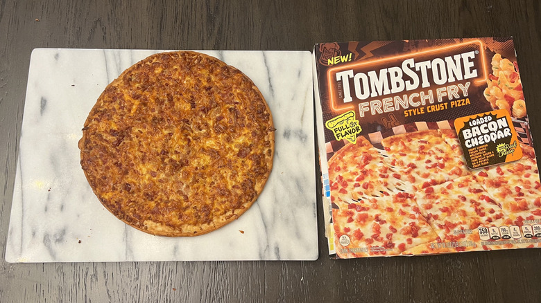 Tombstone Loaded Bacon Cheddar French Fry Crust Pizza on serving board.