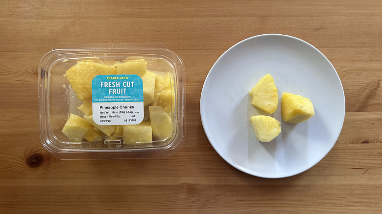 Trader Joe's fresh cut pineapple chunks on wooden table