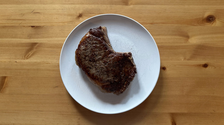 Bone-in Ribeye on white plate