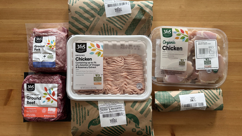 Packaged meats from Whole Foods on wooden table