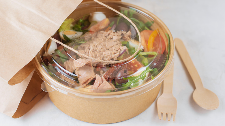 Takeout container with salad inside