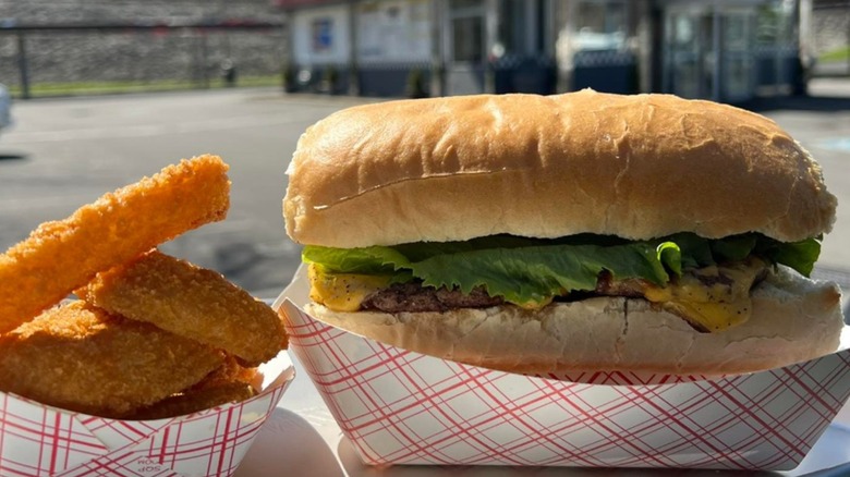 Burger and onion rings in front of diner