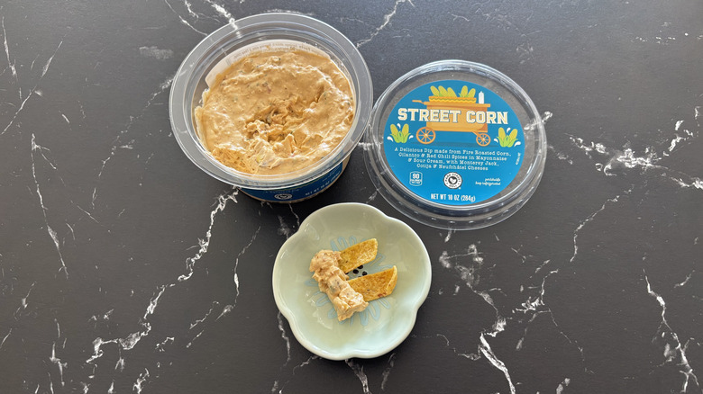 Aldi street corn dip container next to bowl with Fritos and dip