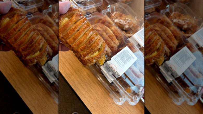 A person holding a Peaches and Cream Pastry from Costco with a package of the pastries in the background