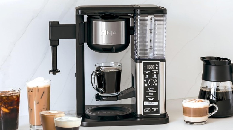 The Ninja Specialty Coffee Maker CM401 on a kitchen counter next to glass cups of coffee beverages