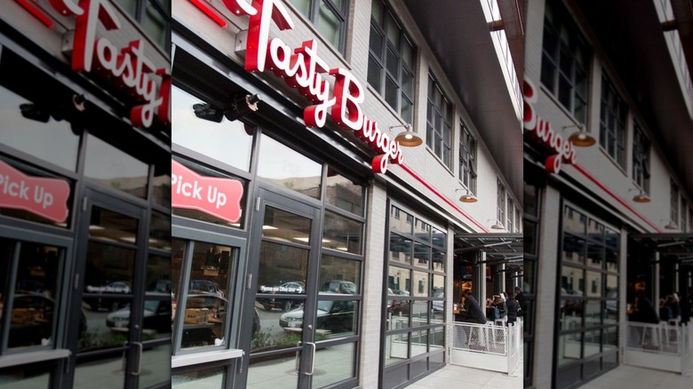 Front of Tasty Burger restaurant with red sign