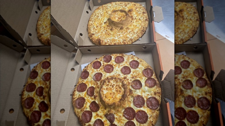 A plain cheese and a pepperoni volcano Dipper pizza from Pizza Pizza viewed from overhead. Each Pizza has a large dough bowl baked into the center of it covered in melted cheese