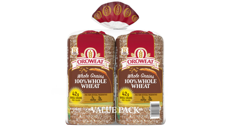 Two loaves of whole wheat bread in plastic bag adorned with wheat motifs