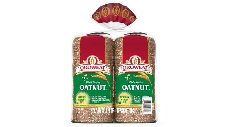 Two loaves of Oroweat oatnut bread in plastic bag with wheat motifs