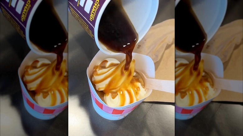 Coffee pouring out of cup onto McDonald's plain McFlurry ice cream in paper cup